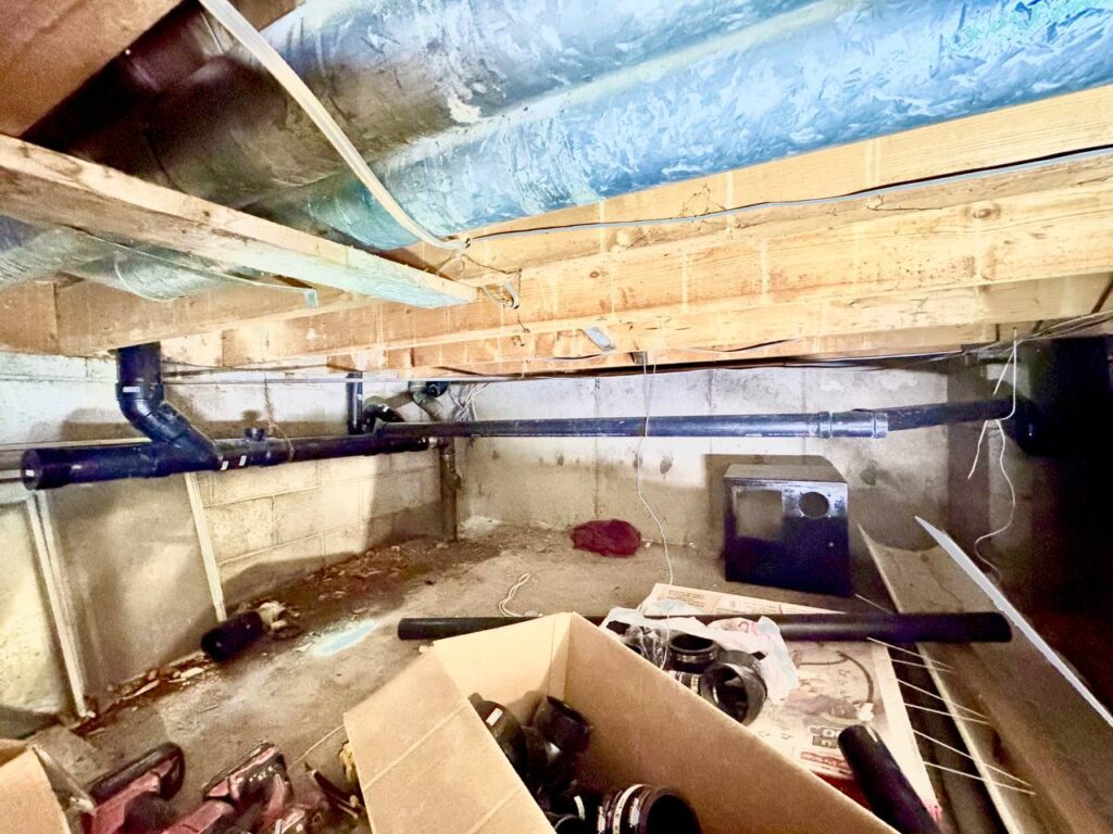 Professional plumber installing new PVC hot and cold water piping in residential home renovation in Toronto