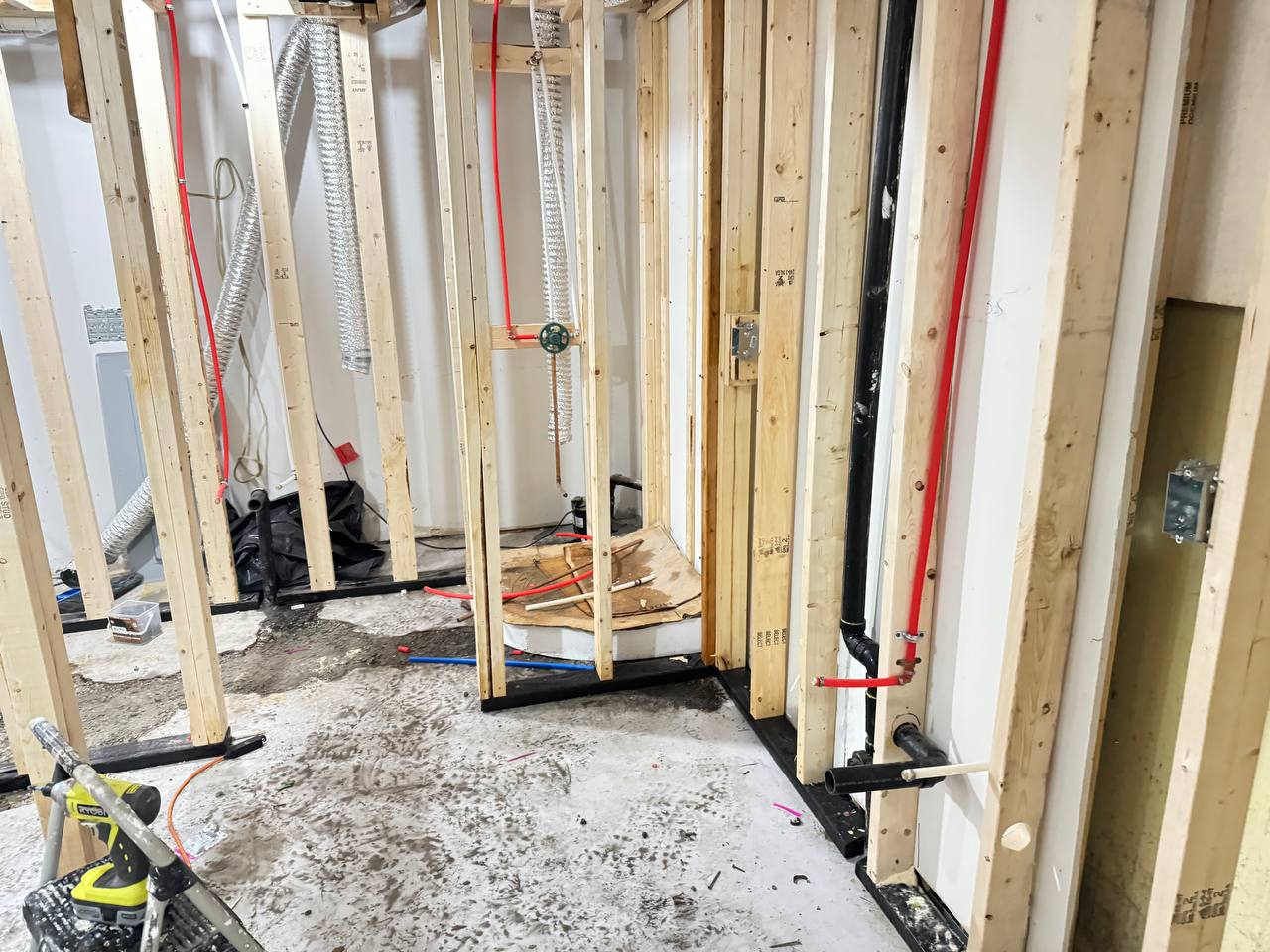 Professional plumber installing new PVC hot and cold water piping in residential home renovation in Toronto